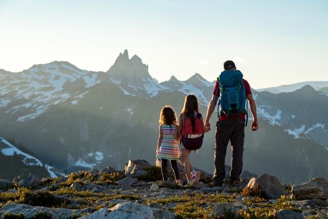 A family hiking to new horizons in the mountains